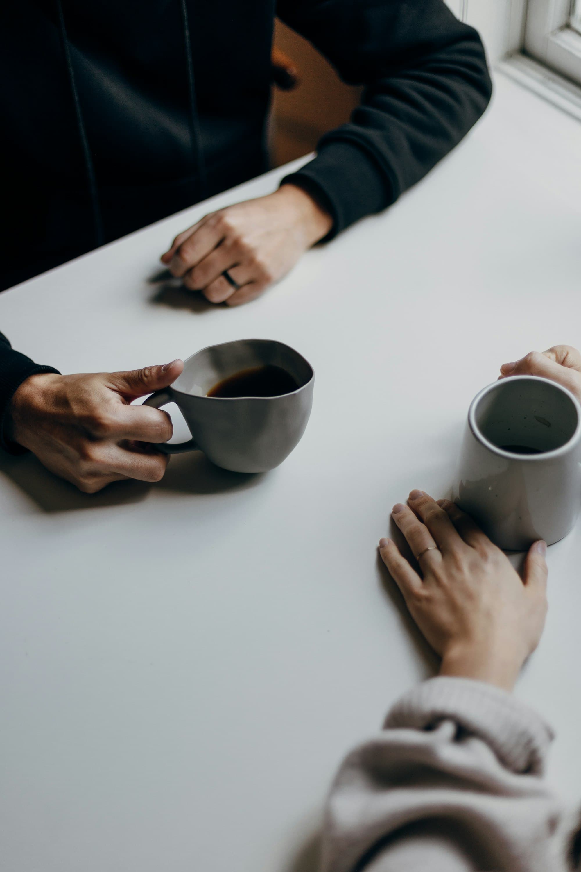 Two people talking something through over coffee